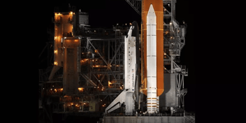 space shuttle at night, hasn't yet launched - photo credit NASA/Bill Ingsall